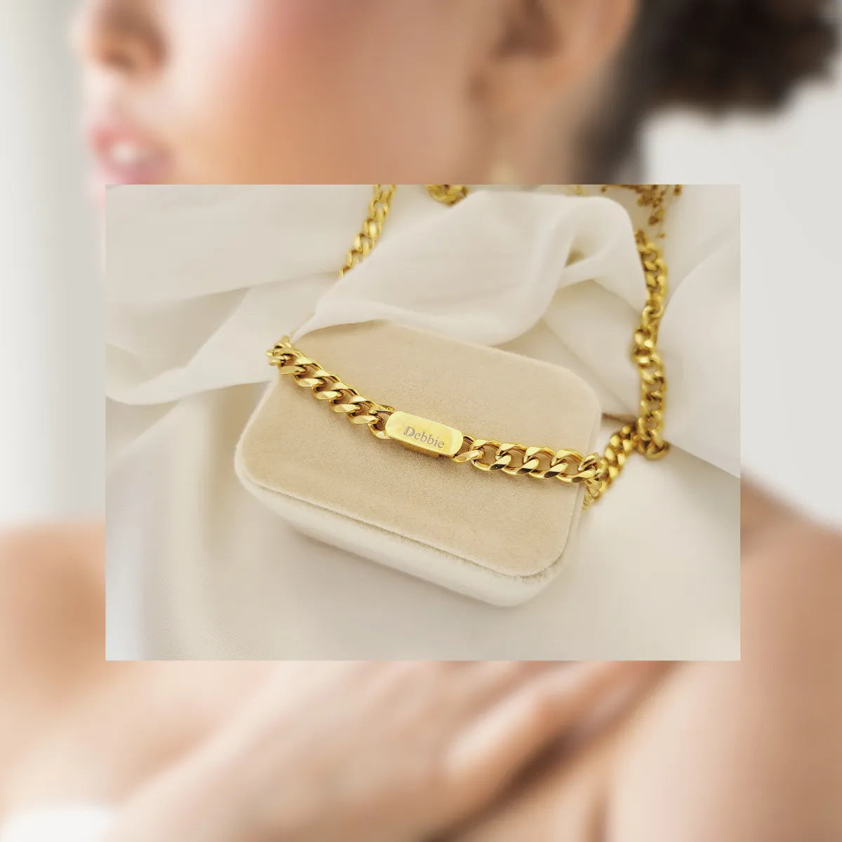 an image showing a customized piece of jewelry, with "Debbie" written on top of a gold label showcasing the customizability aspect of handmade jewelry. 