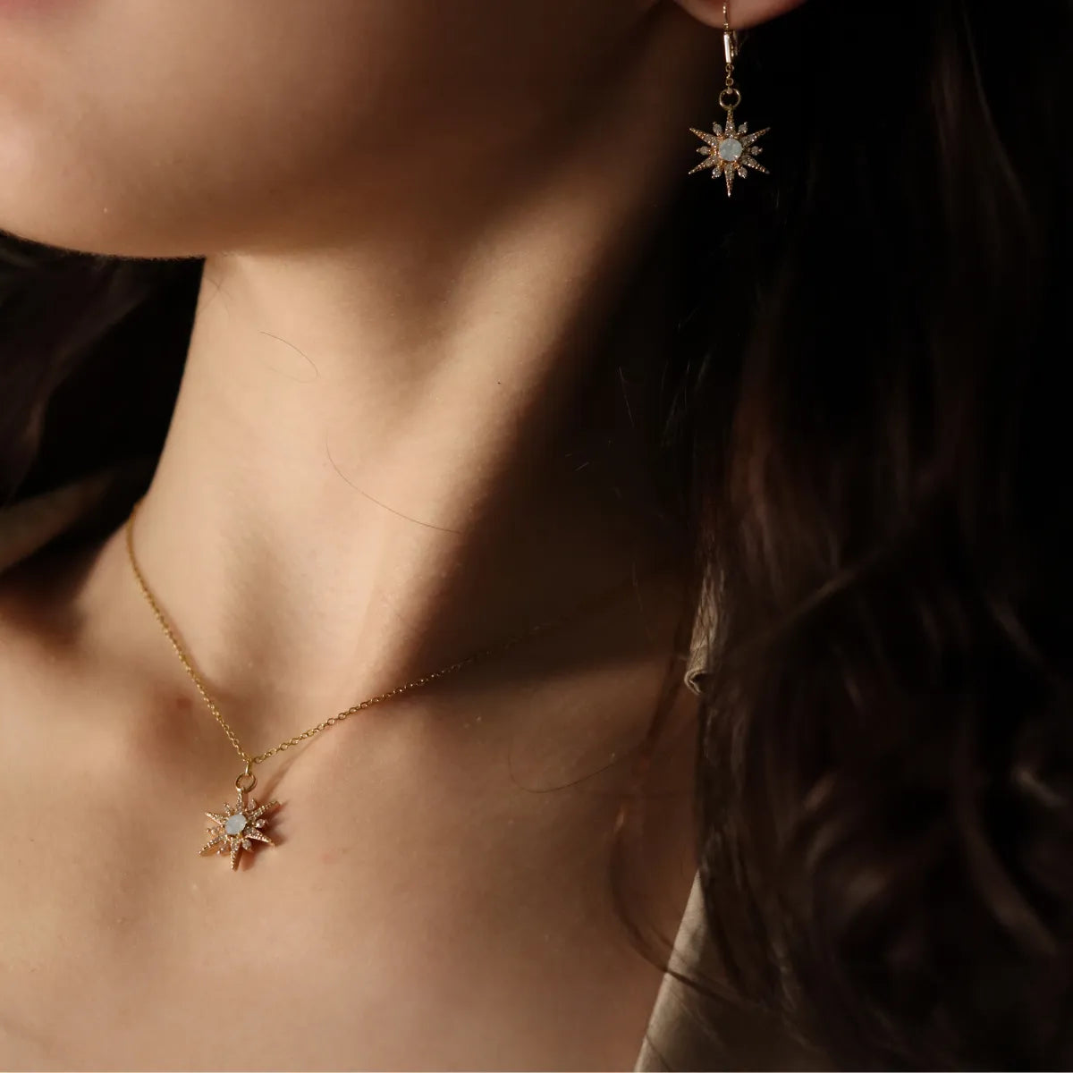 A woman wearing star shaped handmade jewelry with matching earrings.