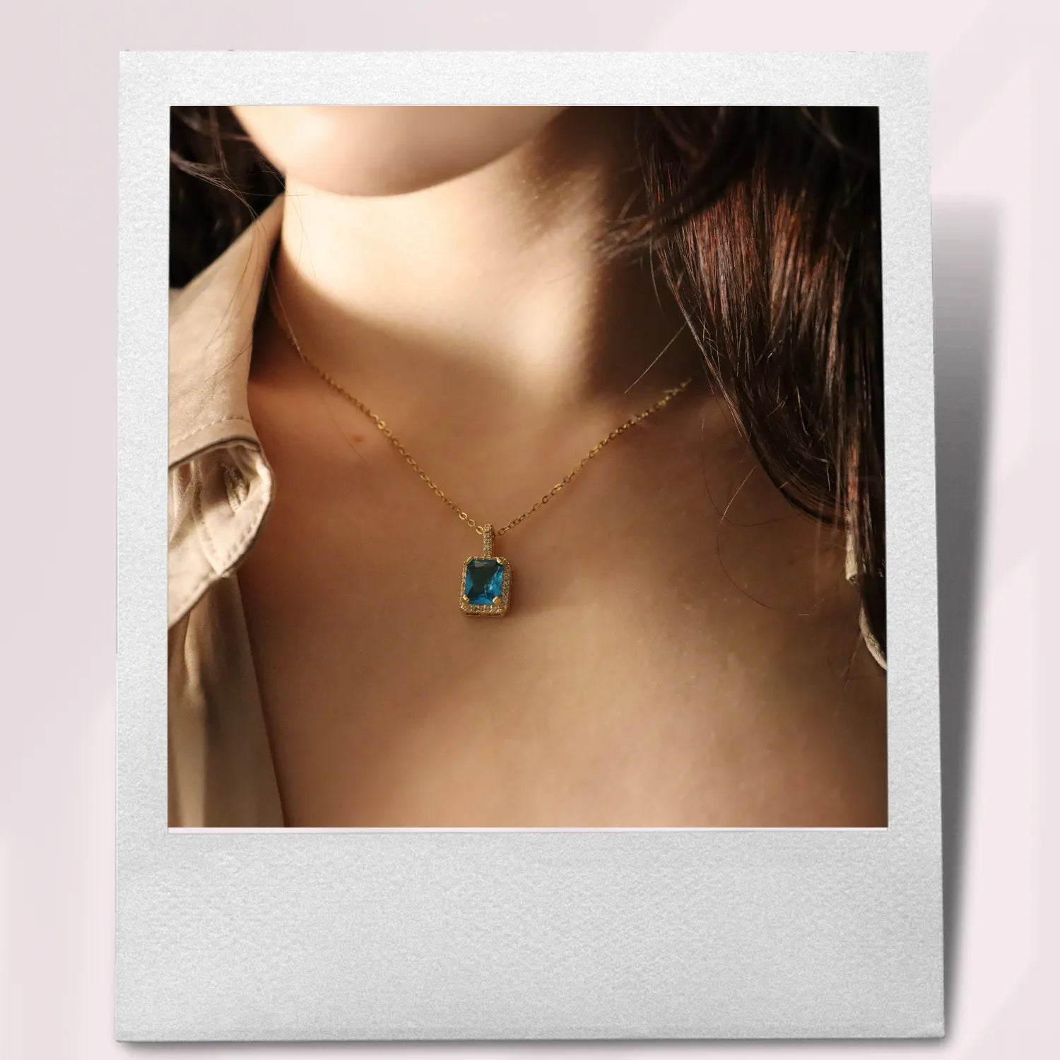 Woman wearing a blue sapphire necklace.